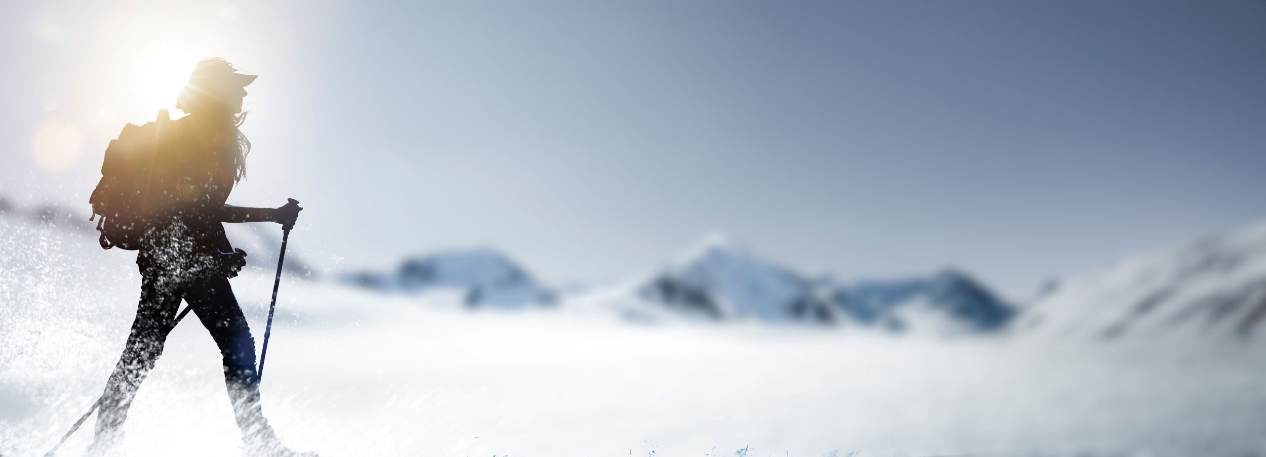 A woman hiking in the snow.